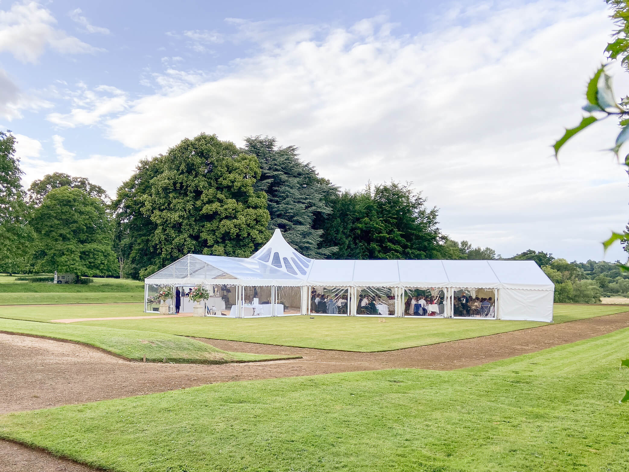 A marquee set up on the green lawn out back of the manor for a Rousham House wedding.
