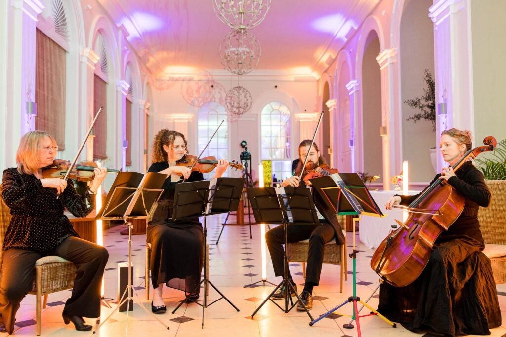 A strings quartet plays as entertainment at a wedding at Blenheim Palace.