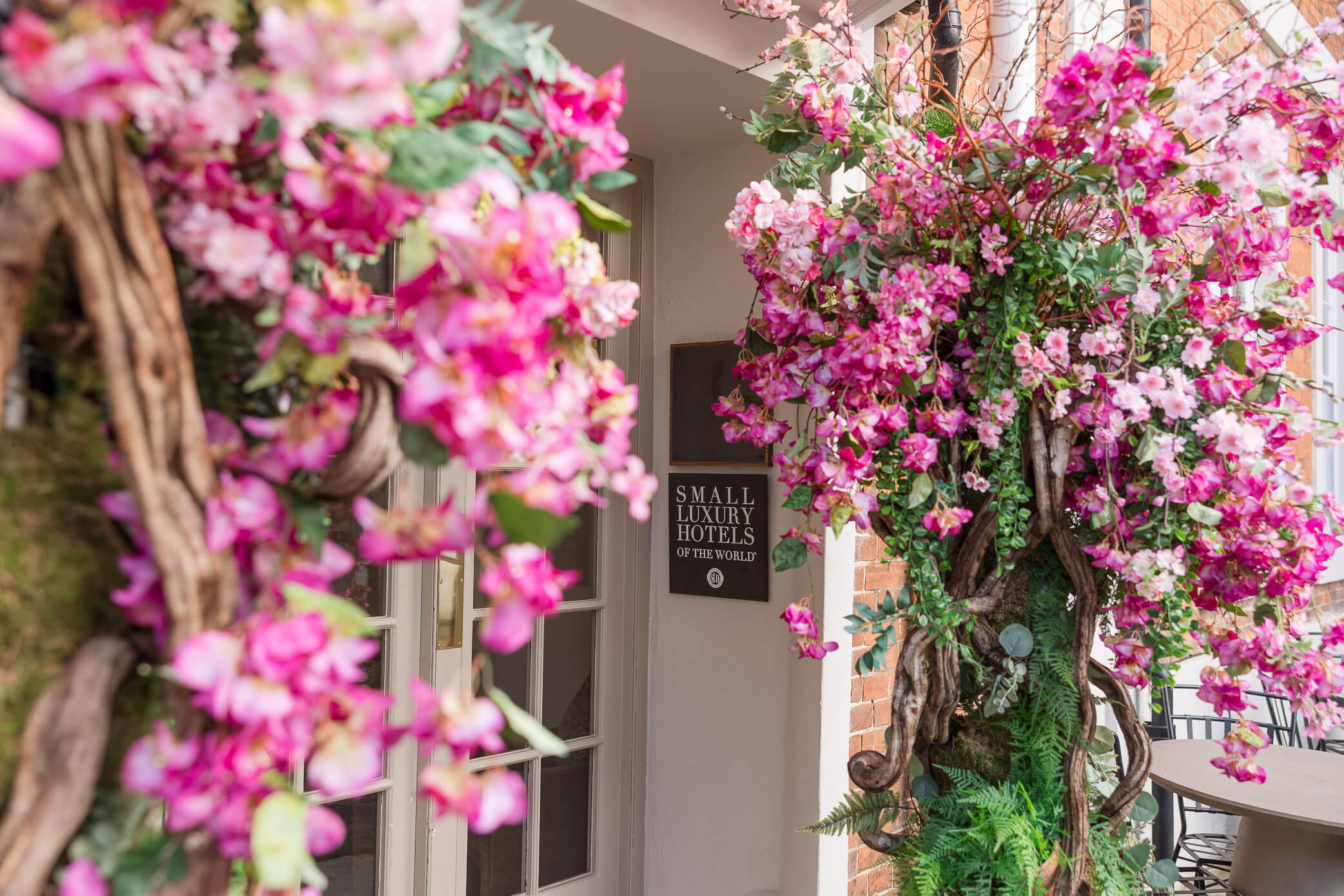 A close up of the Feathers Inn hotel entrance with a sign that says "Small Luxury Hotels of the World"