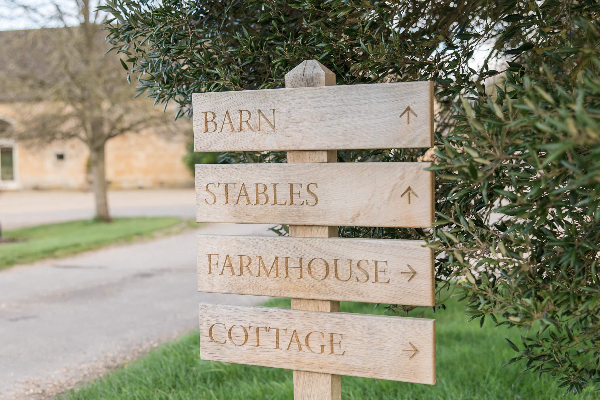 The wooden sign pointing guests in the direction to find their venue and accommodation.