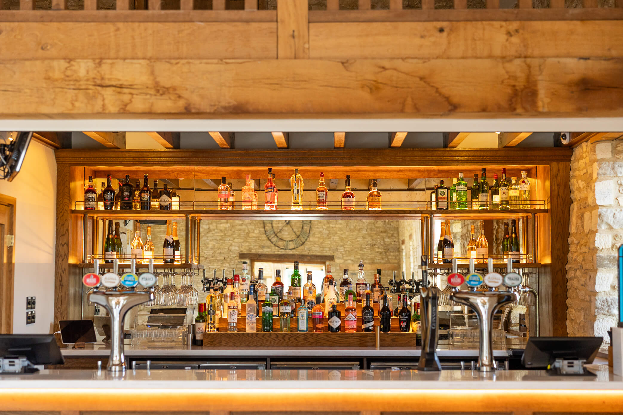 Fully stocked bar in the Oak Barn at Caswell House