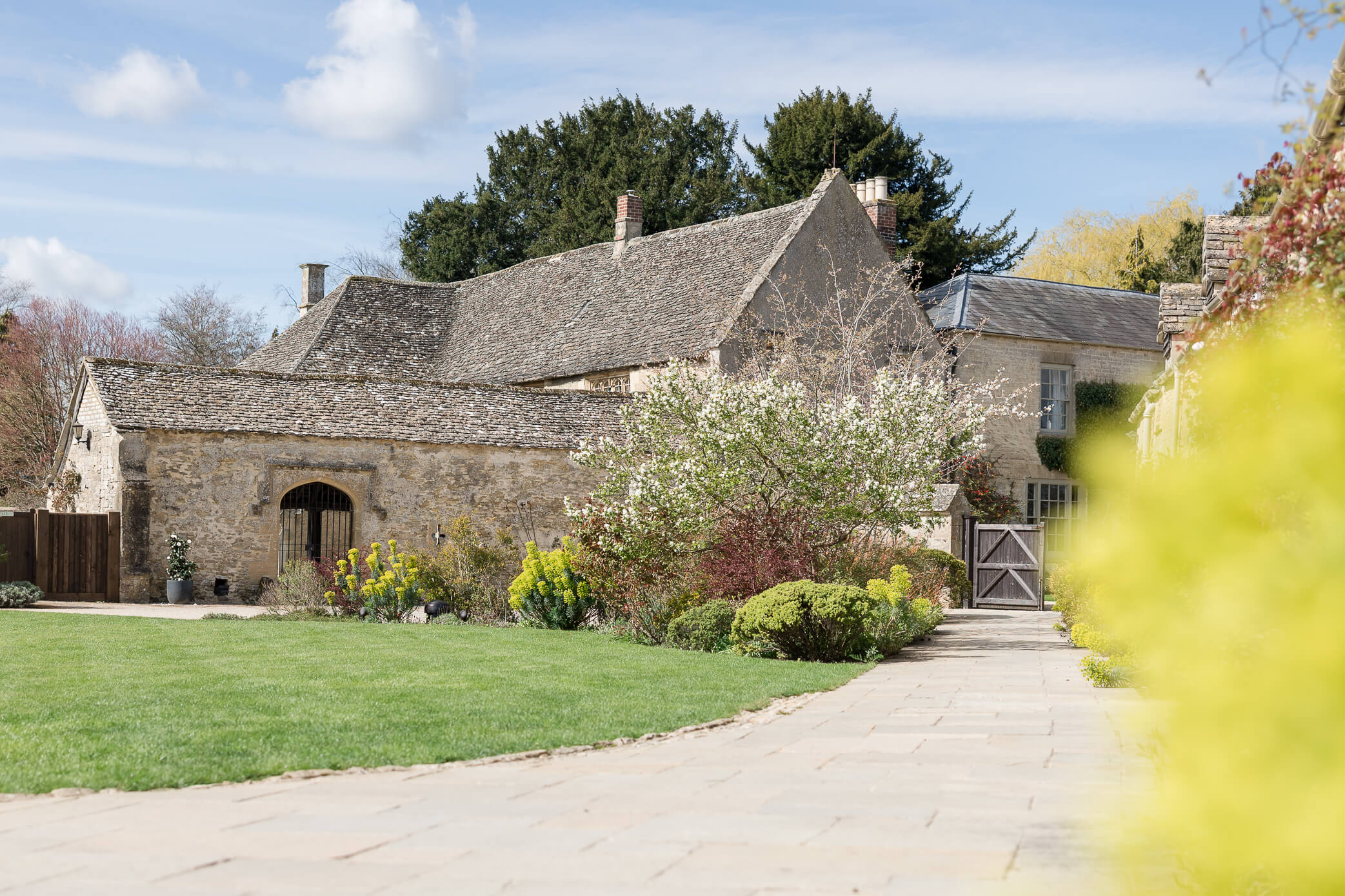 Caswell House courtyard with soft blooms and greenery in the foreground