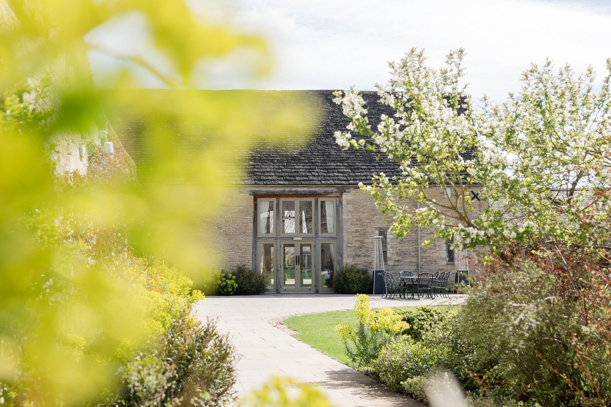 Outside of Caswell House barn with soft blooms and greenery in the foreground
