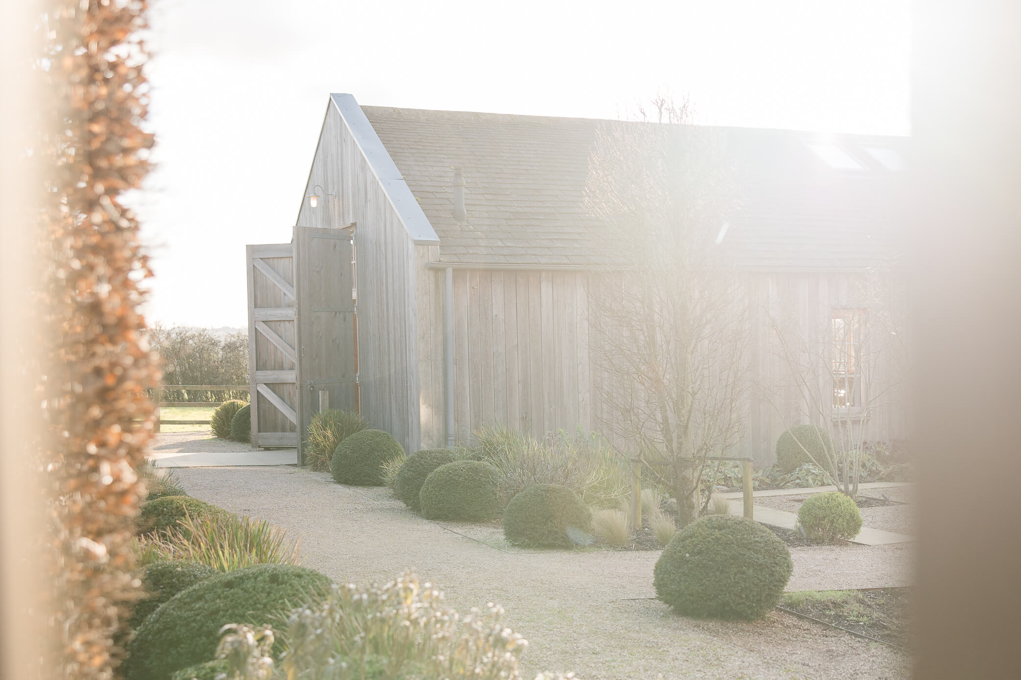 Outside of the barn ceremony venue for a Hyde House wedding at sunset