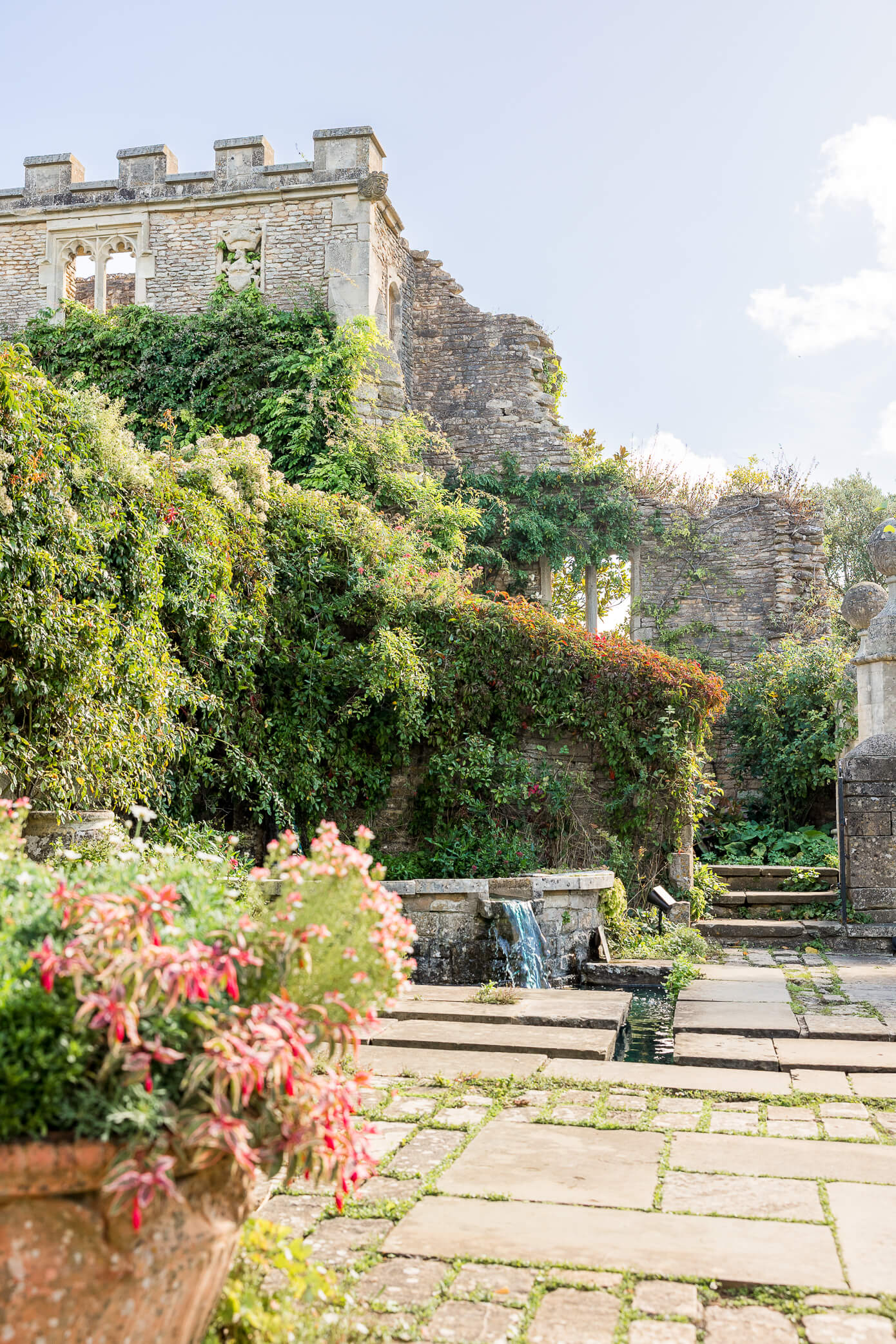 The ruins of Euridge Manor with a reflection pond and fountain on a tiered surface