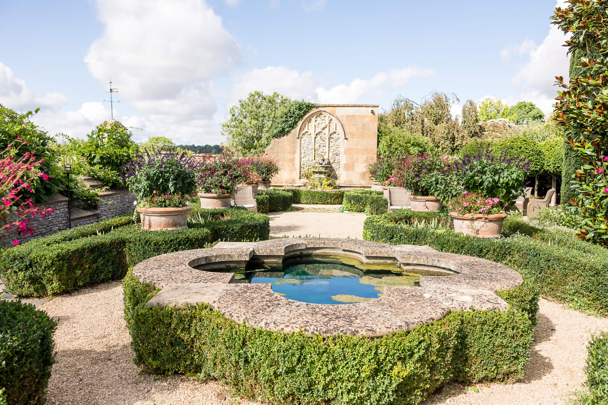 The Orangery Terrace with a little reflection pool filled with water beneath a blue sky