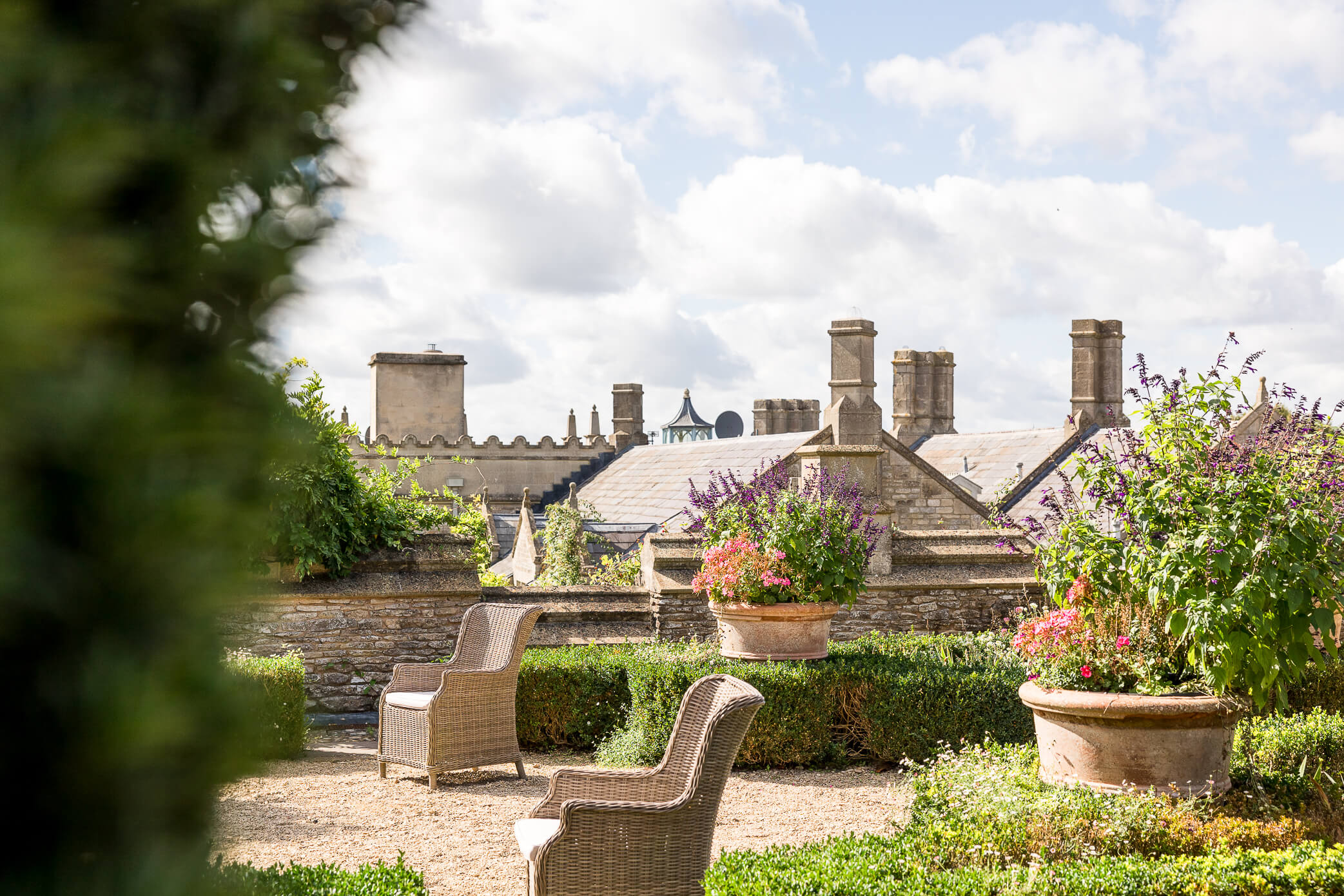 View of some chairs on top of the Orangery Terrace overlooking the rooftops of Euridge Manor