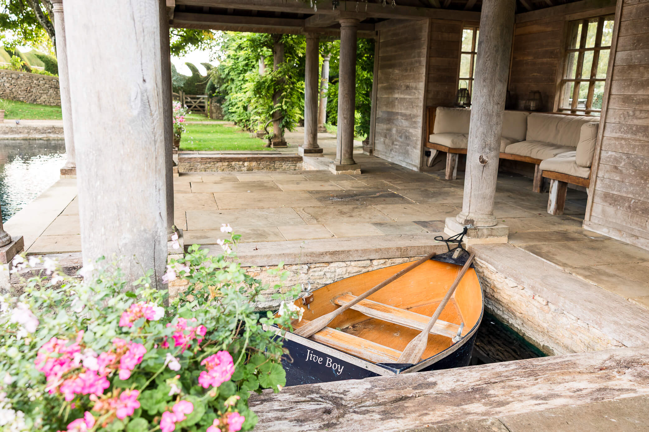 The wooden rowing boat beneath the boathouse